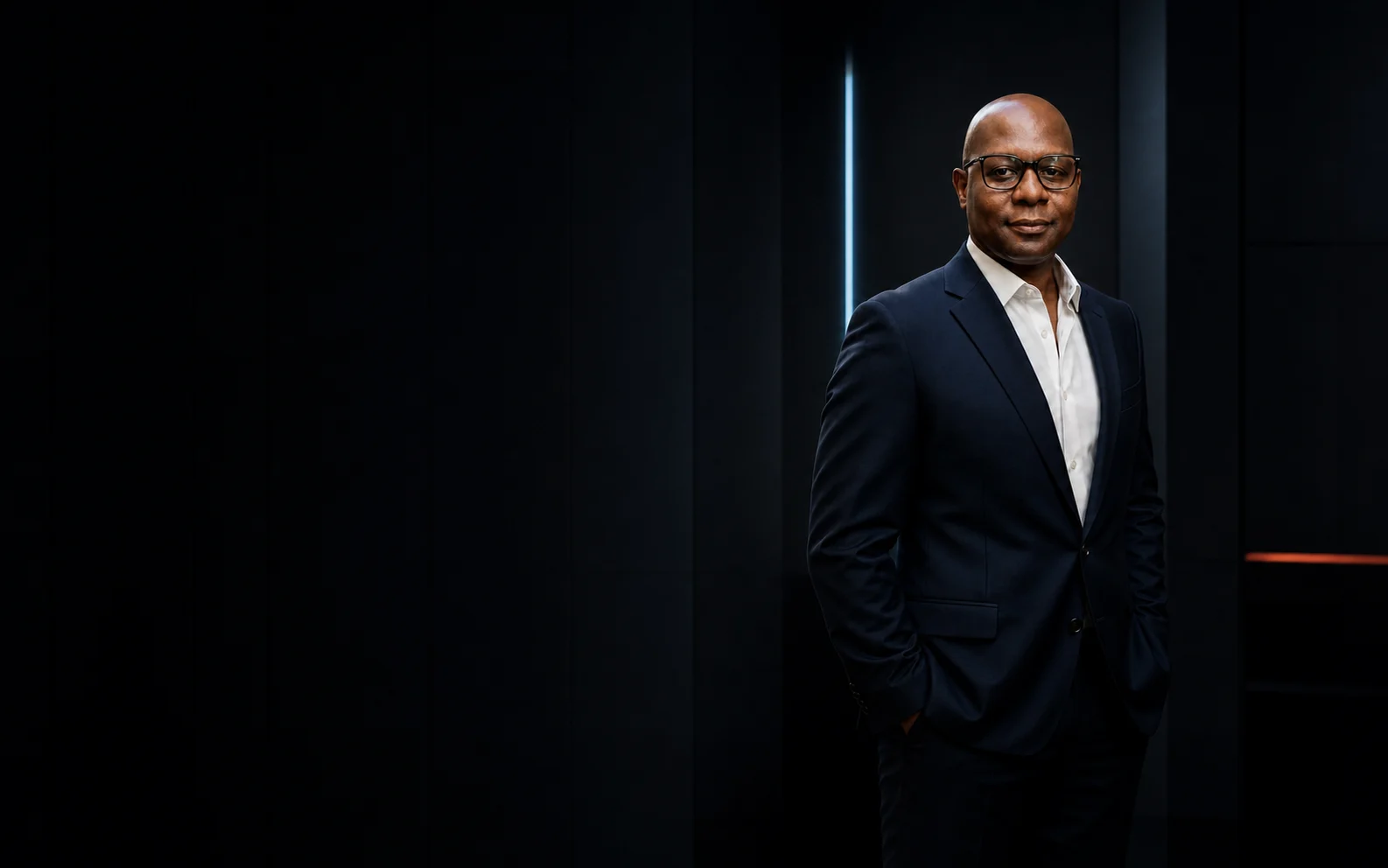 Keith Staggers, an AI trainer and workflow builder, in a dark studio portrait